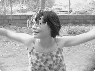 A girl wears sunglasses that say cool as an example of being sober chic