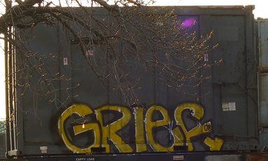 A building features the word grief in graffiti as a symbol for how to stay true to recovery during grief