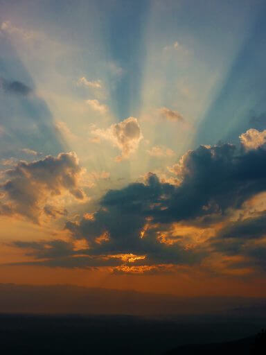 A sunrise through the clouds represents how to start over after rehab