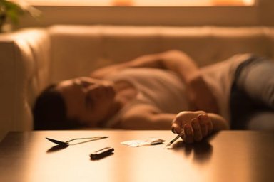 Passed out man on couch with polysubstance abuse 