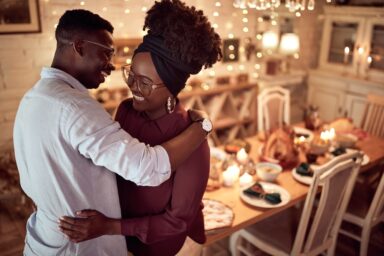 African American couple embracing while celebrating Thanksgiving day
