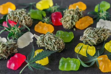 Delta 9 gummies with dried weed and cannabis leaves