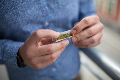 Man rolling a marijuana joint