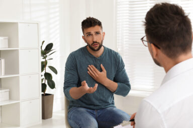 Man talking to a psychotherapist for heroin addiction treatment
