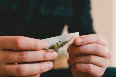 Man rolling a marijuana joint