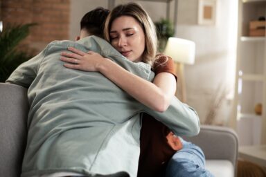 Woman hugging her partner who lost a loved one in addiction
